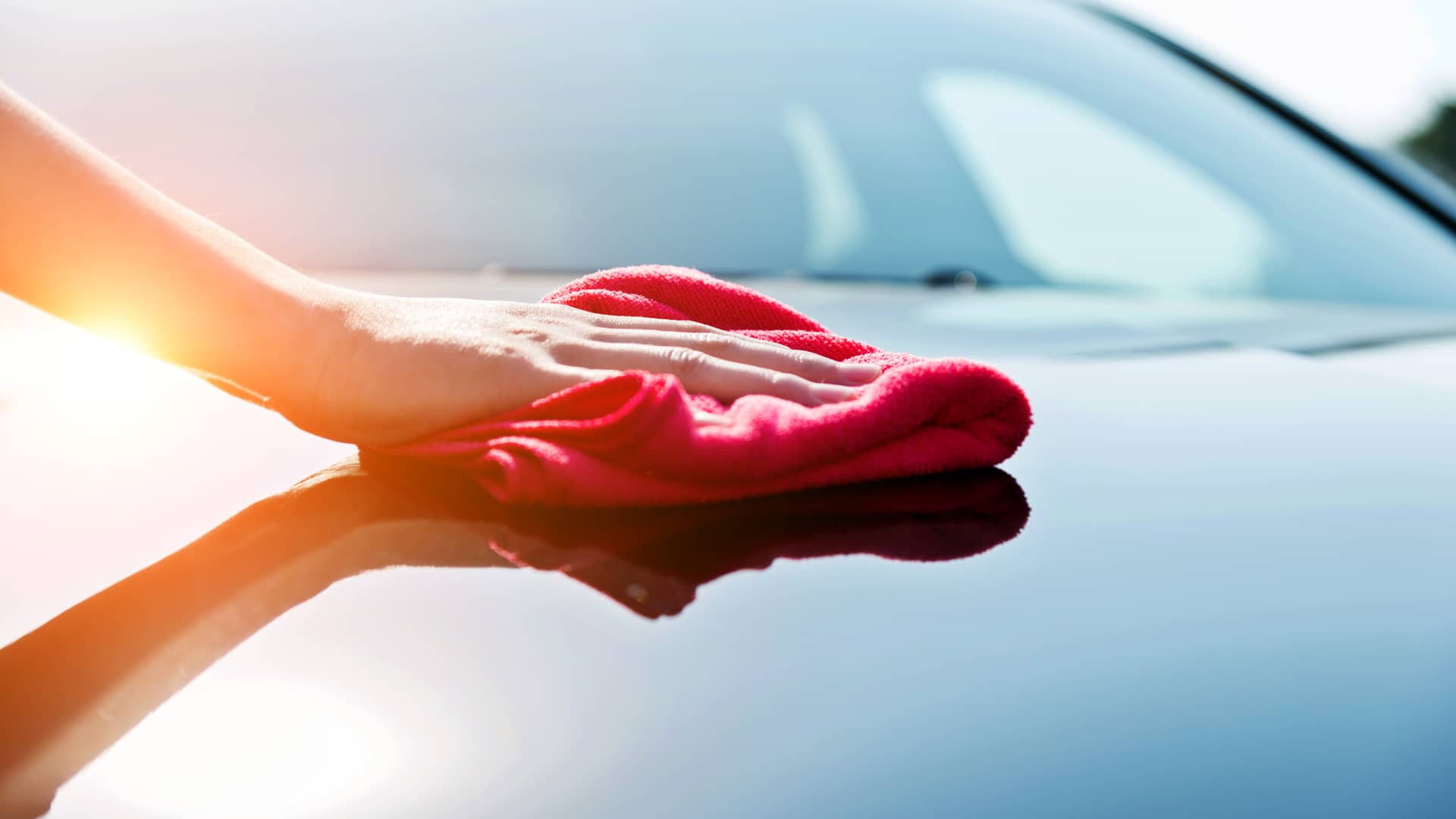 Mujer limpiando su coche asegurado con seguro banco santander